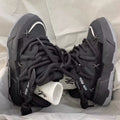 Women's grey retro clunky sneakers with a thick rubber sole and flat heel on a plain background.