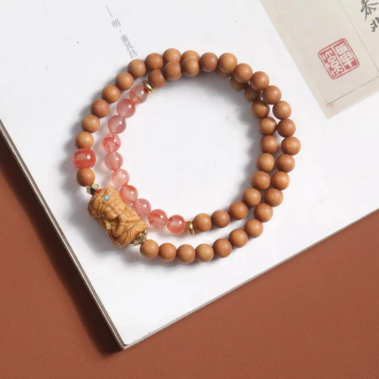 Brown sandalwood bracelet with woven South Red Zachilam design and 6mm round beads