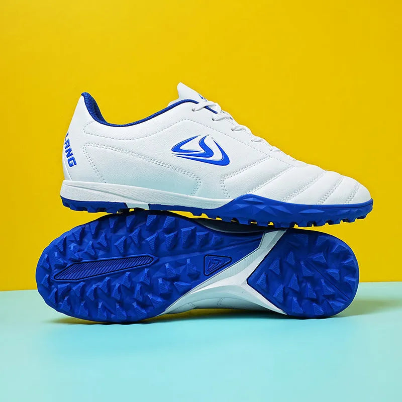 Low-top turf soccer shoes in black and white broken nails colour with synthetic leather upper