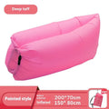 Yellow smiling face tip inflatable sofa inflated on green grass for camping