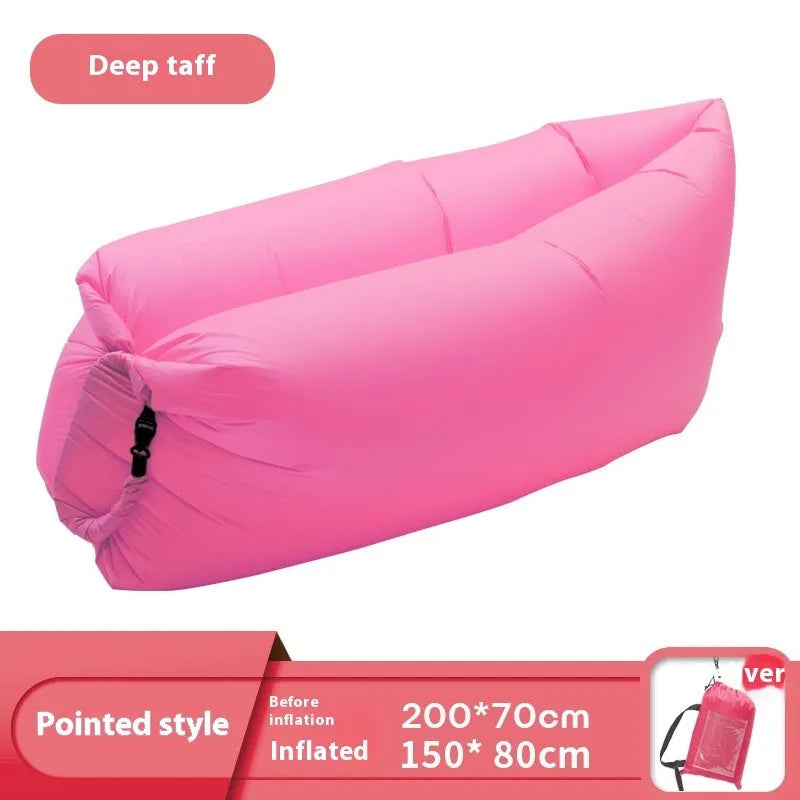 Yellow smiling face tip inflatable sofa inflated on green grass for camping