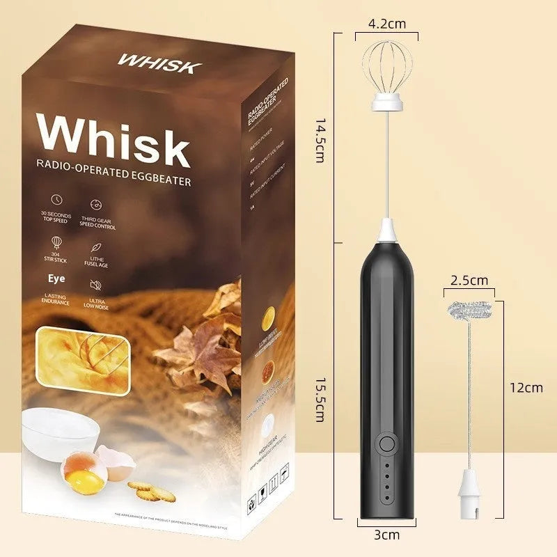 Compact black handheld electric milk frother with a stainless steel whisk and USB charging port.