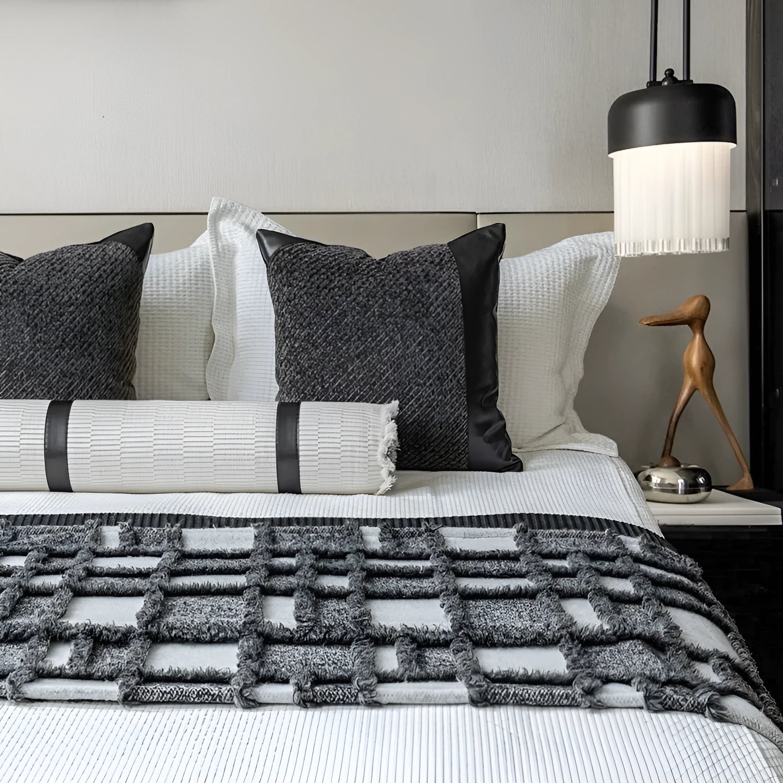 Modern grey and white plaid bed runner nap blanket set with pillow on a bed.