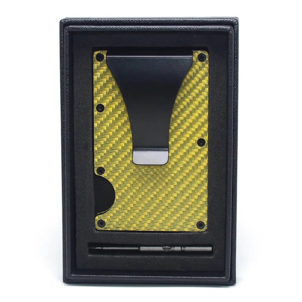 Geometric carbon fibre and aluminium business card holder, 8mm thick, on a table.