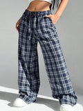Women's red plaid trousers with drawstring waist and side pockets on mannequin display