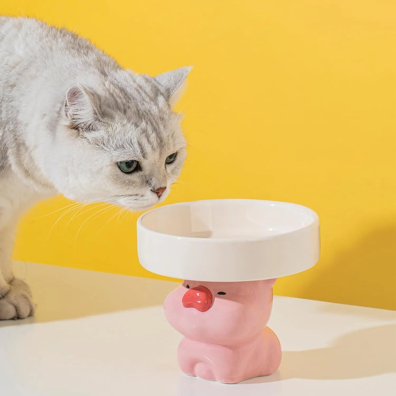 Raised ceramic pet bowl in animal design, showing wide opening for whisker comfort