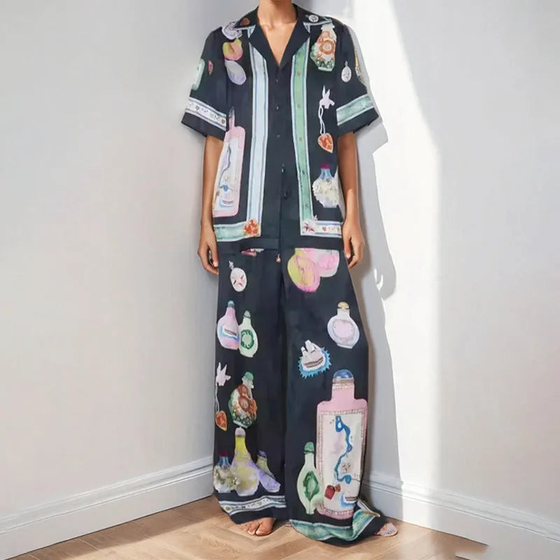 Black women's cardigan and trouser set with cartoon print, showing front view.