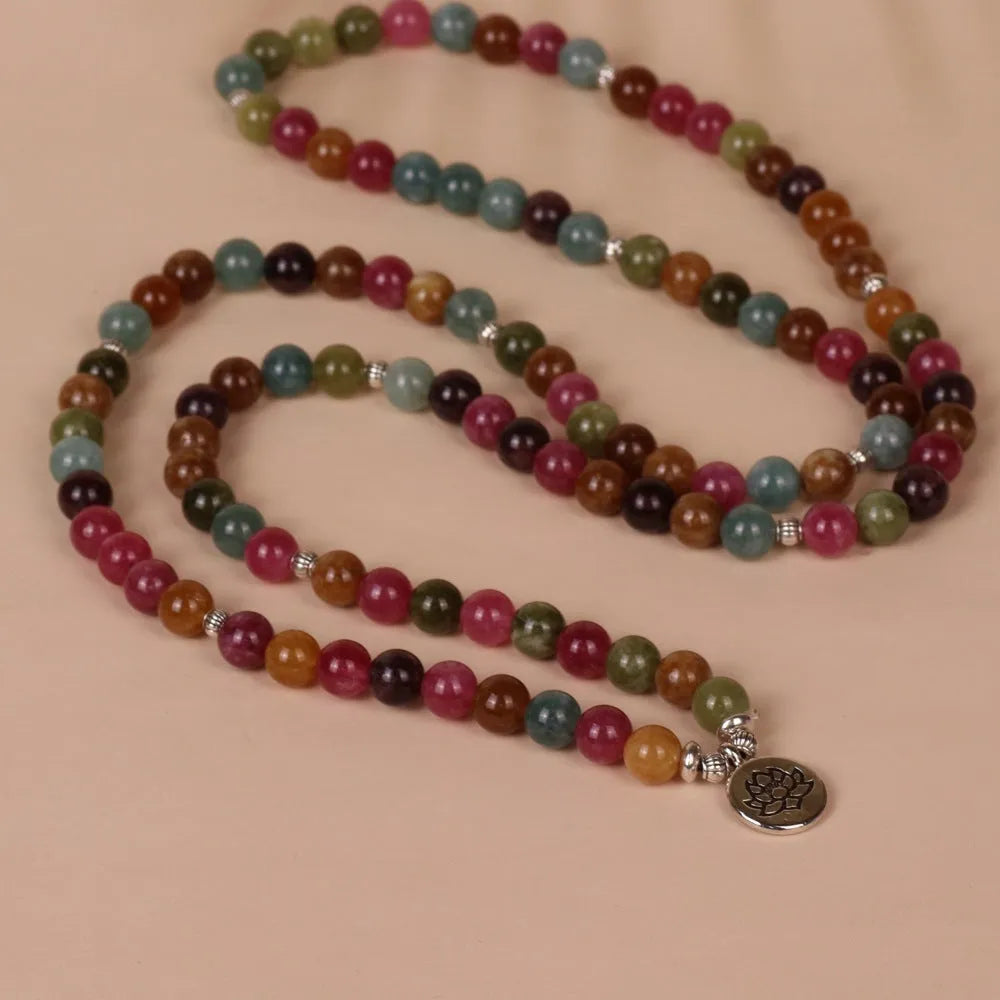 108-bead multi-layer bracelet with hanging lotus ornament in tourmaline-coloured alloy.