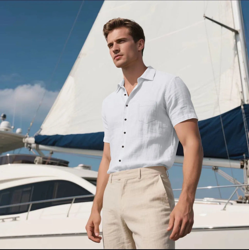Man wearing a loose-fit, light blue, short-sleeved linen shirt in a cardigan style.