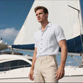 Man wearing a loose-fit, light blue, short-sleeved linen shirt in a cardigan style.