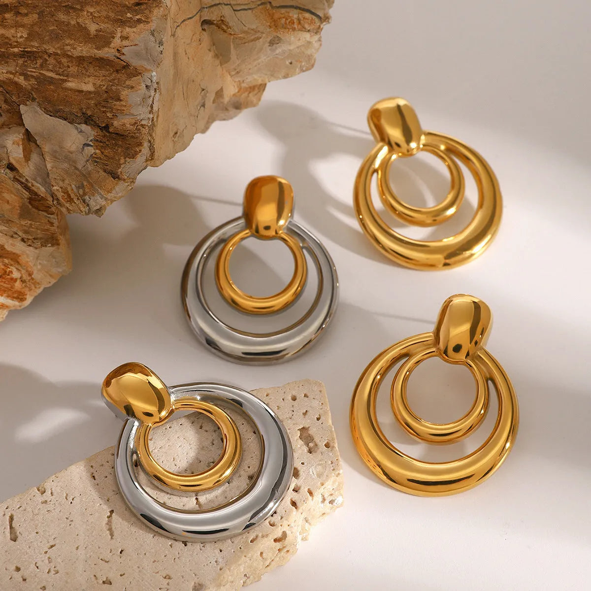 Gold geometric round stud earrings with double-layer hollow design on titanium steel posts