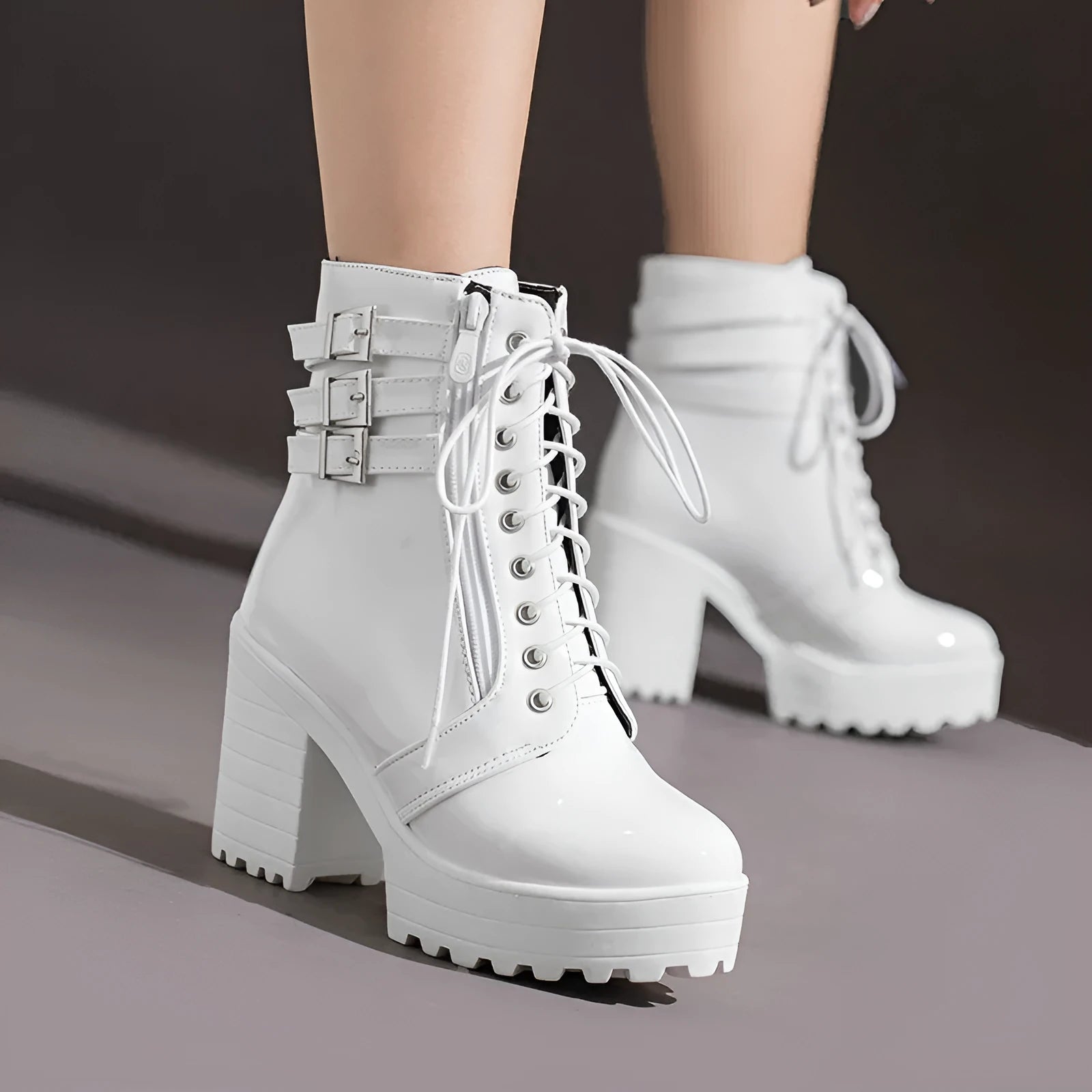 Women's black thick-heeled lace-up ankle boots with a round toe and waterproof platform sole.