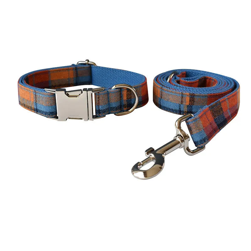 Blue background velvet plaid dog collar with a silver alloy metal buckle on a white surface.