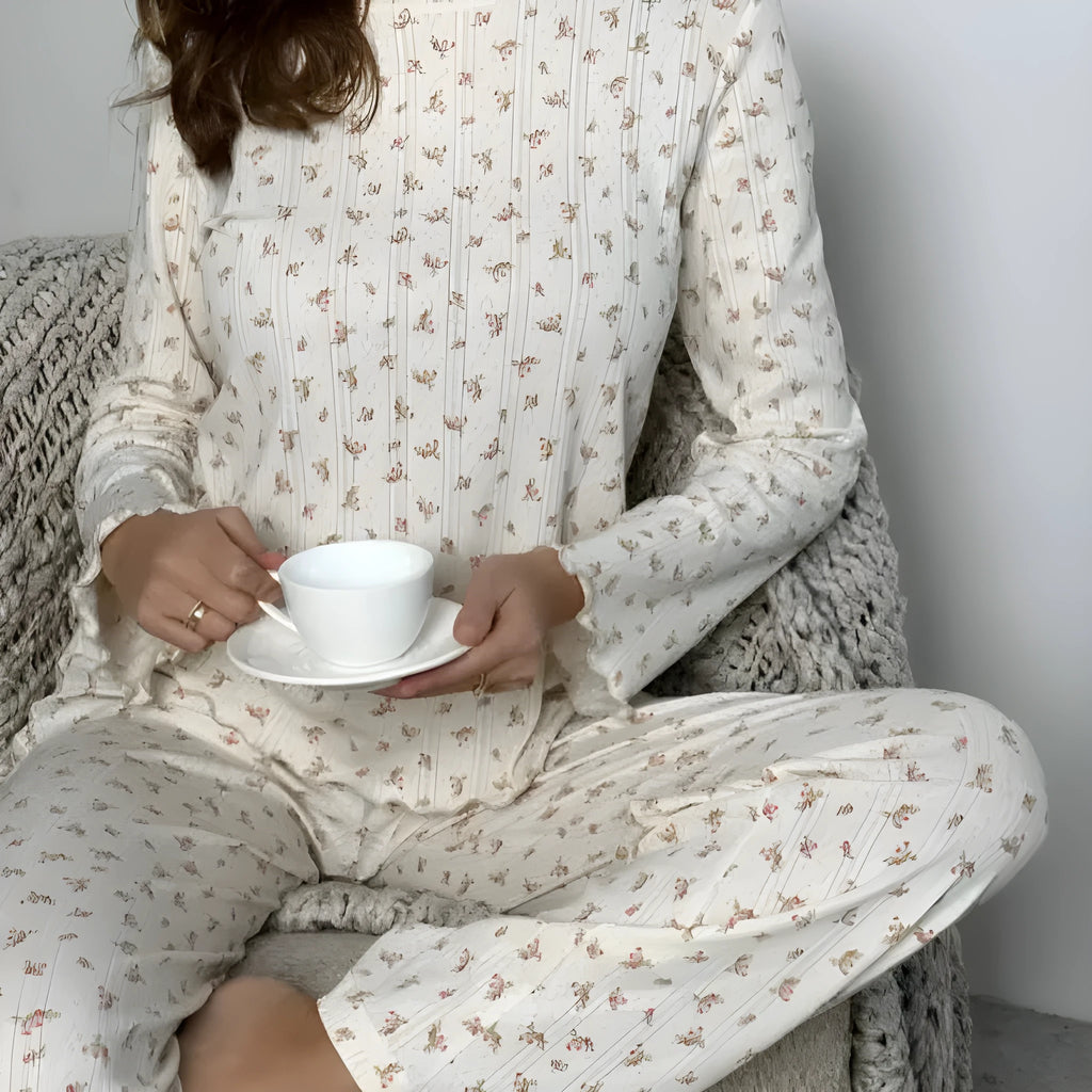 White floral print women's suit with bell sleeve top and wide leg trousers on hanger