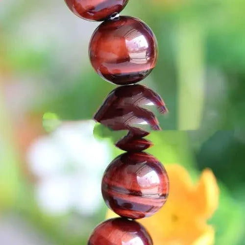 Handmade tiger's eye gemstone bracelet with lightning cat's eye pattern in geometric round beads