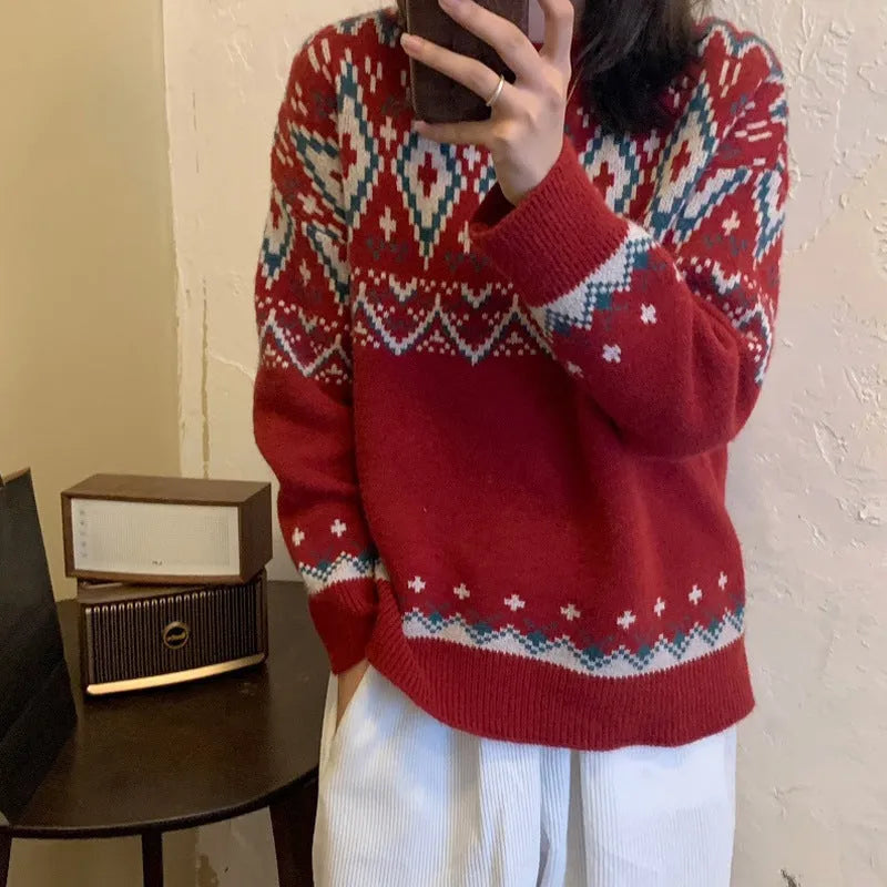 Red and white striped loose-fit long sleeve pullover knitted top on a hanger.