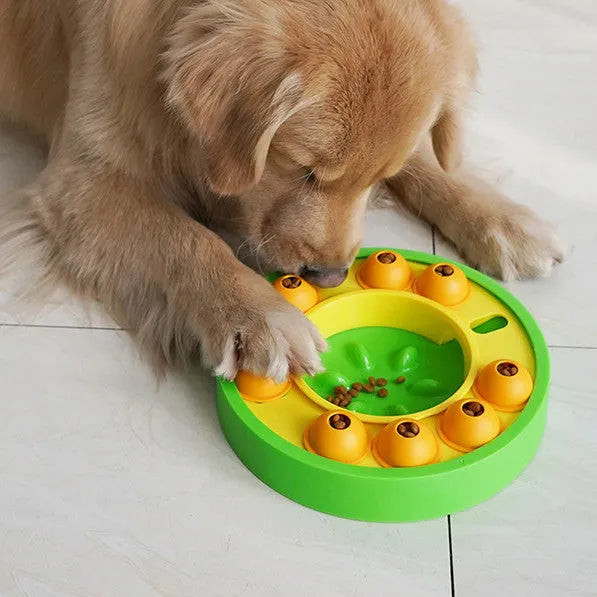 Round blue interactive dog slow feeder puzzle toy with central column and food turntable on a table