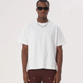 A loose fit pure cotton T-shirt in apricot colour on a hanger, showing short sleeves and casual style.