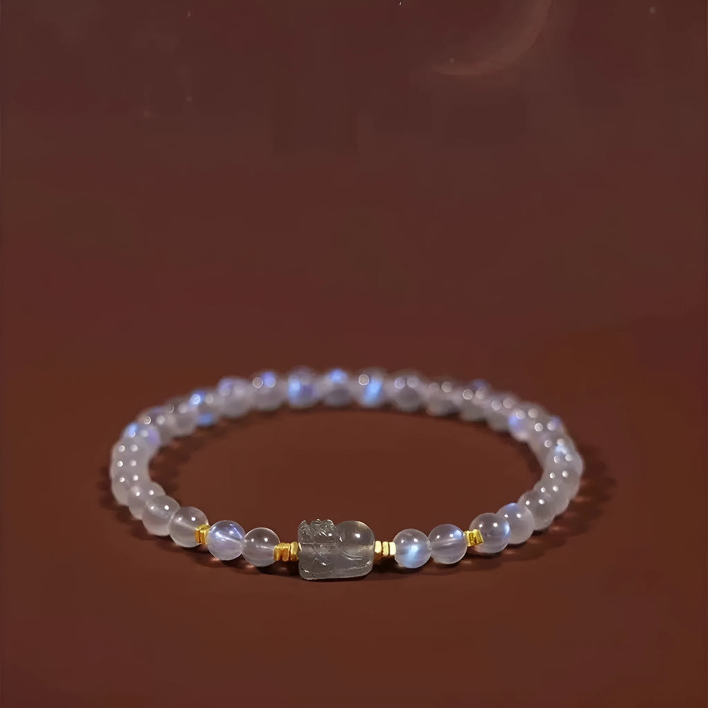 Close-up of a women's moonstone bracelet with zodiac animal design in a traditional Chinese style.