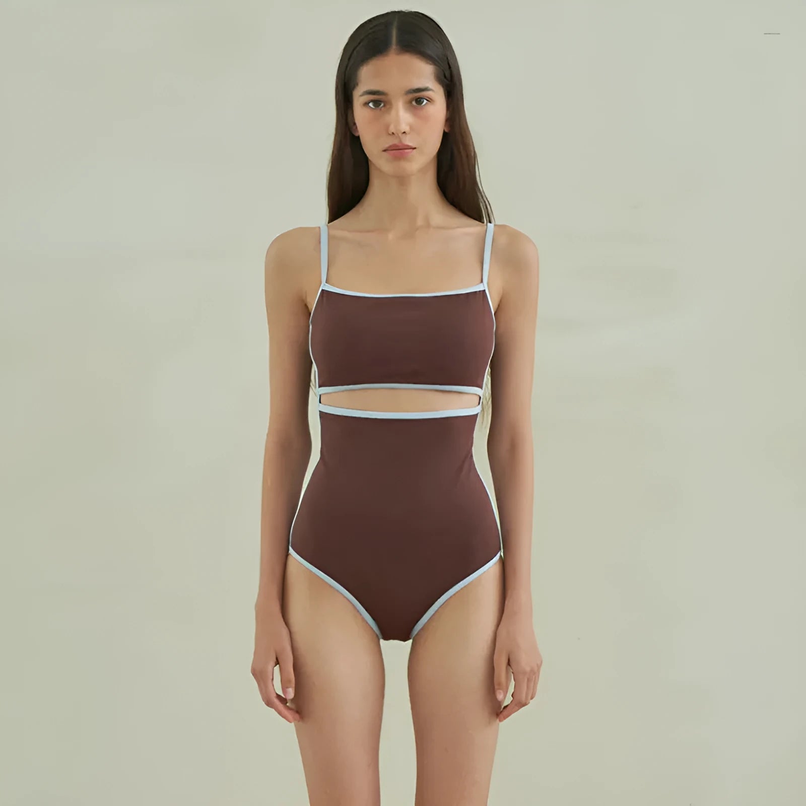 Brown triangle style one-piece swimsuit for women on a hanger