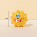 Set of four coloured squeaky dog balls with cute faces, made from natural latex rubber.
