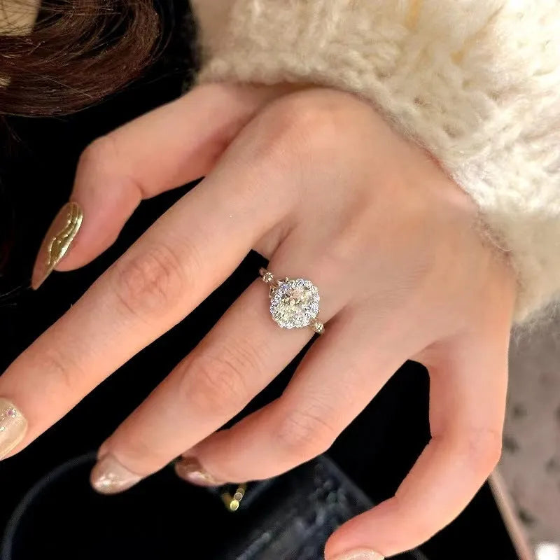 Silver geometric ellipse diamond ring with adjustable opening on a copper band.