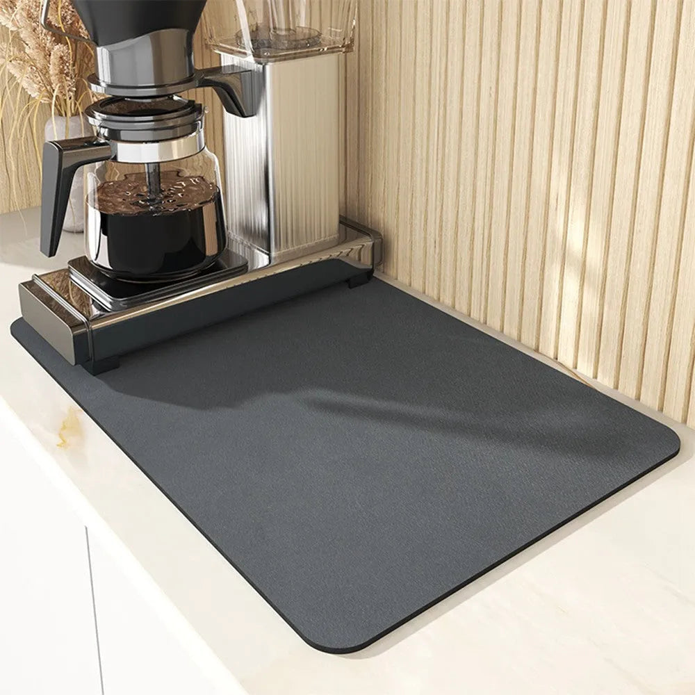 Black square super absorbent PU leather kitchen drain pad drying mat with anti-slip backing on a countertop.