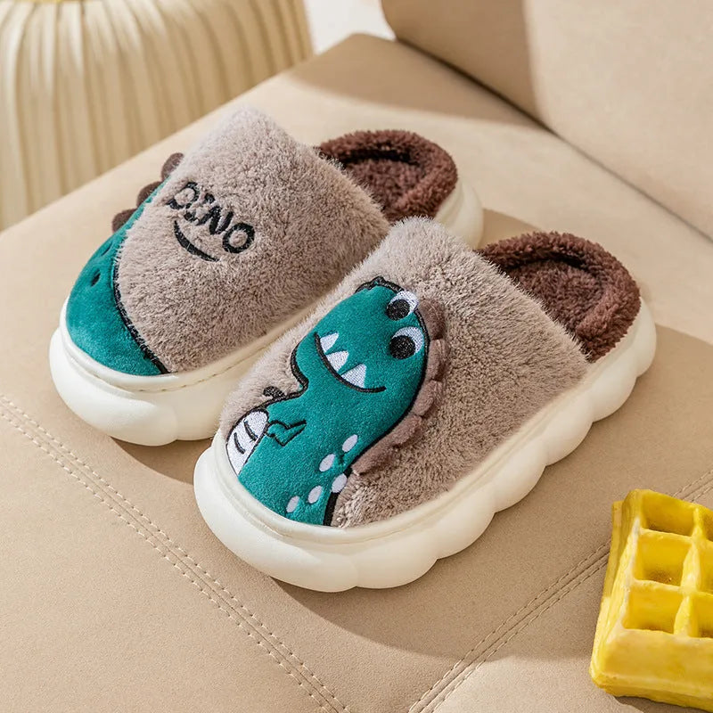A pair of grey dinosaur print cotton slippers with plush lining, shown from above.