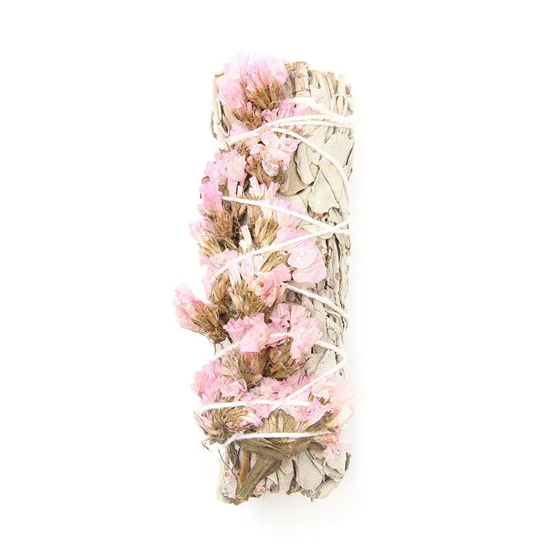 White sage and red rose petal colourful aromatherapy incense bundle on a wooden table