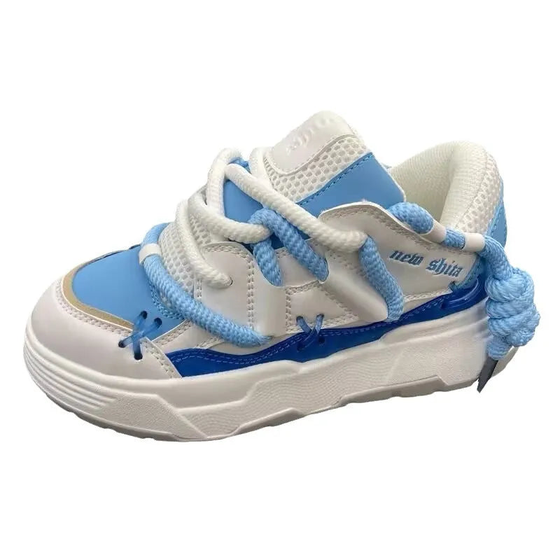 Women's grey retro clunky sneakers with a thick rubber sole and flat heel on a plain background.
