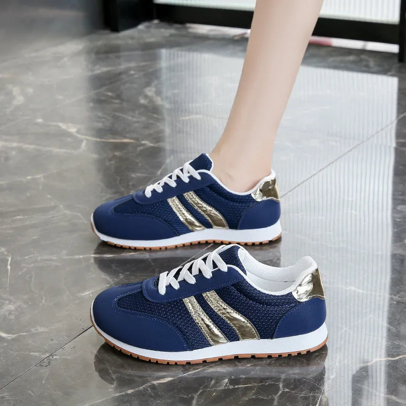 Blue women's casual tennis shoes with cross shoulder straps and a lace-up front on a rubber sole.