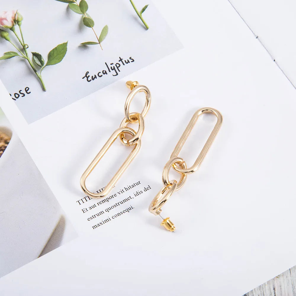 Women's sterling silver colour geometry hoop earrings showing ring and line design elements