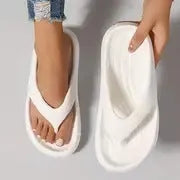 Black women's flip-flops with thick sole and textured non-slip tread.