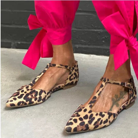 Leopard print women's pointed toe pumps with a low chunky heel and a cross ankle strap.