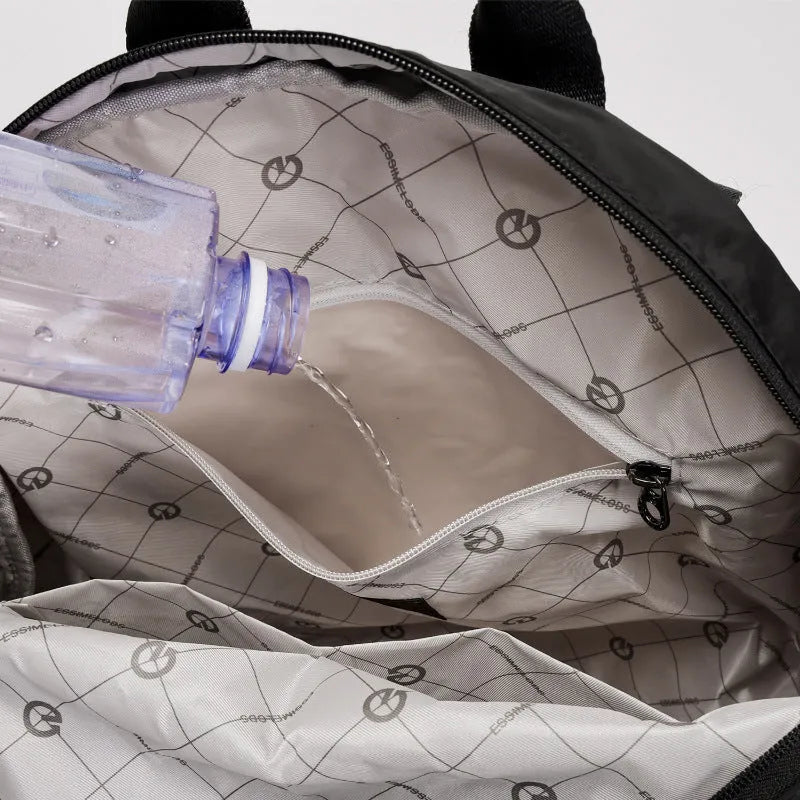Outdoor lightweight large capacity nylon backpack in black, shown with sandwich pocket detail.