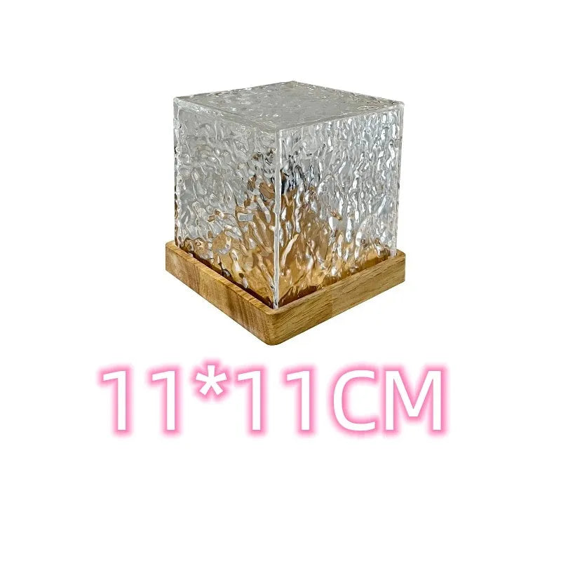 USB-powered crystal table lamp projecting blue water ripple light patterns on a wall