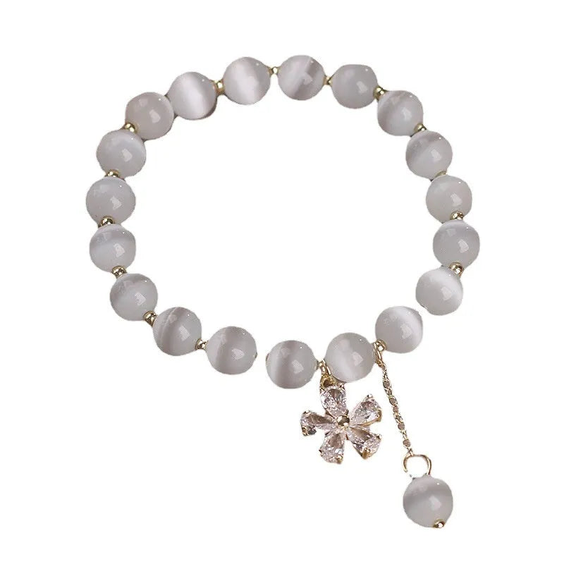 Women's white cat's eye crystal bracelet with floral tassel and morganite safety buckle pendant