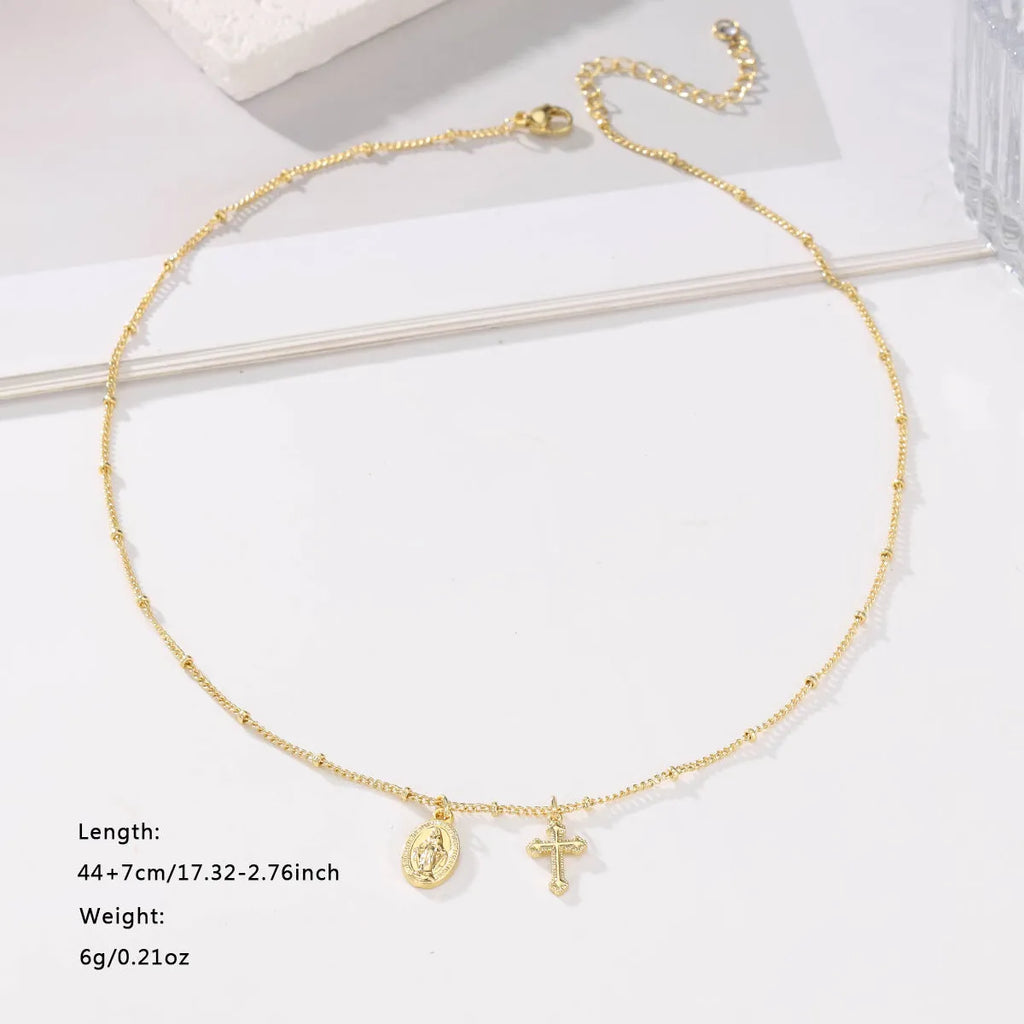 Gold coloured geometric cross necklace with a Virgin Mary ornament pendant for women.