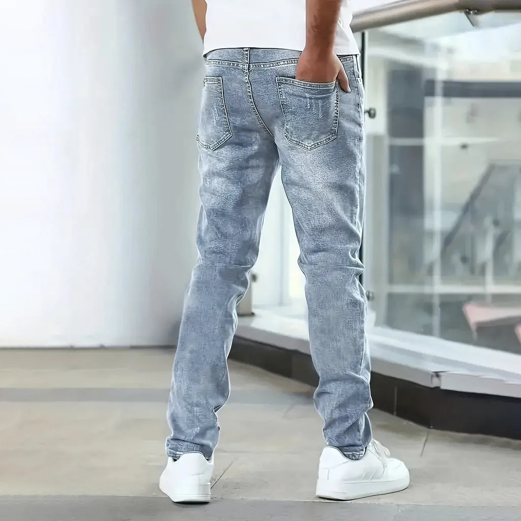 Men's straight-leg stretch jeans in black, dark blue, or grey, showing skinny leg opening and mid-waist fit.