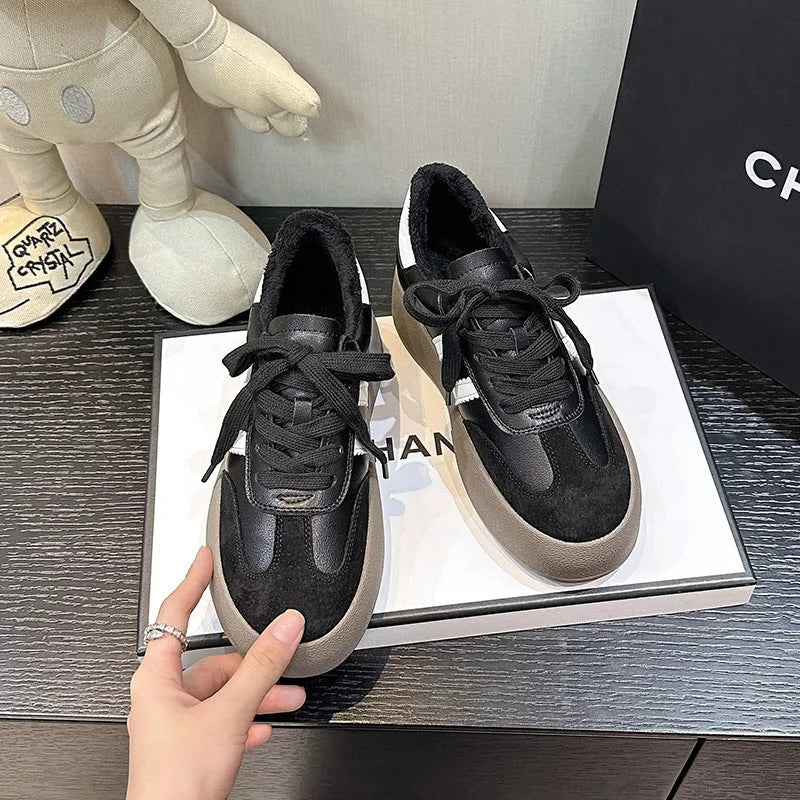 Women's beige distressed leather sneakers with round toe and lace-up front on a rubber sole.