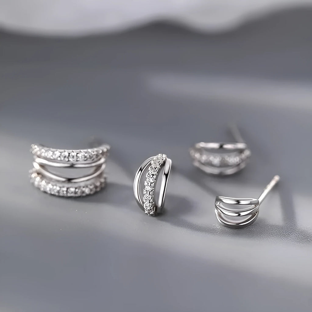 A pair of geometric-shaped 925 silver earrings with silver needle posts, shown in three available sizes.