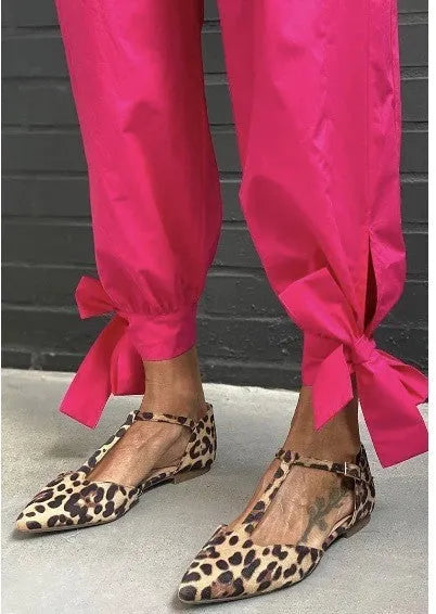 Leopard print women's pointed toe pumps with a low chunky heel and a cross ankle strap.
