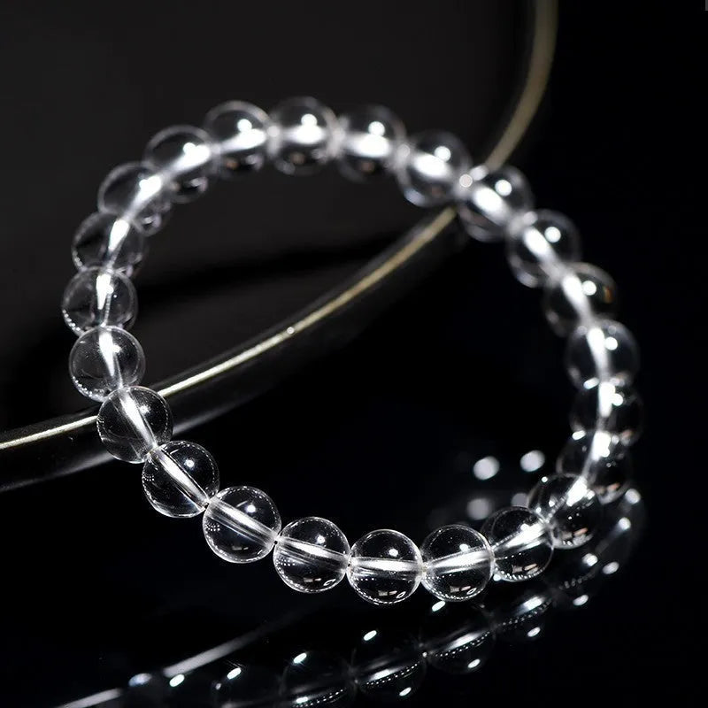 Natural Donghai old materials white crystal geometric bracelet with round beads on a wrist.