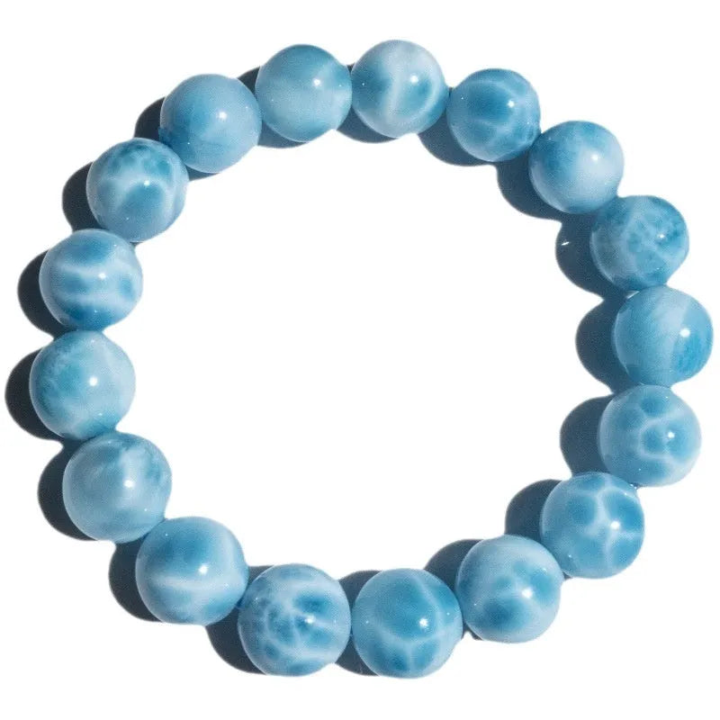 A blue sea-pattern natural crystal and pearl bodhi bracelet in Maillard style, showing bead detail.