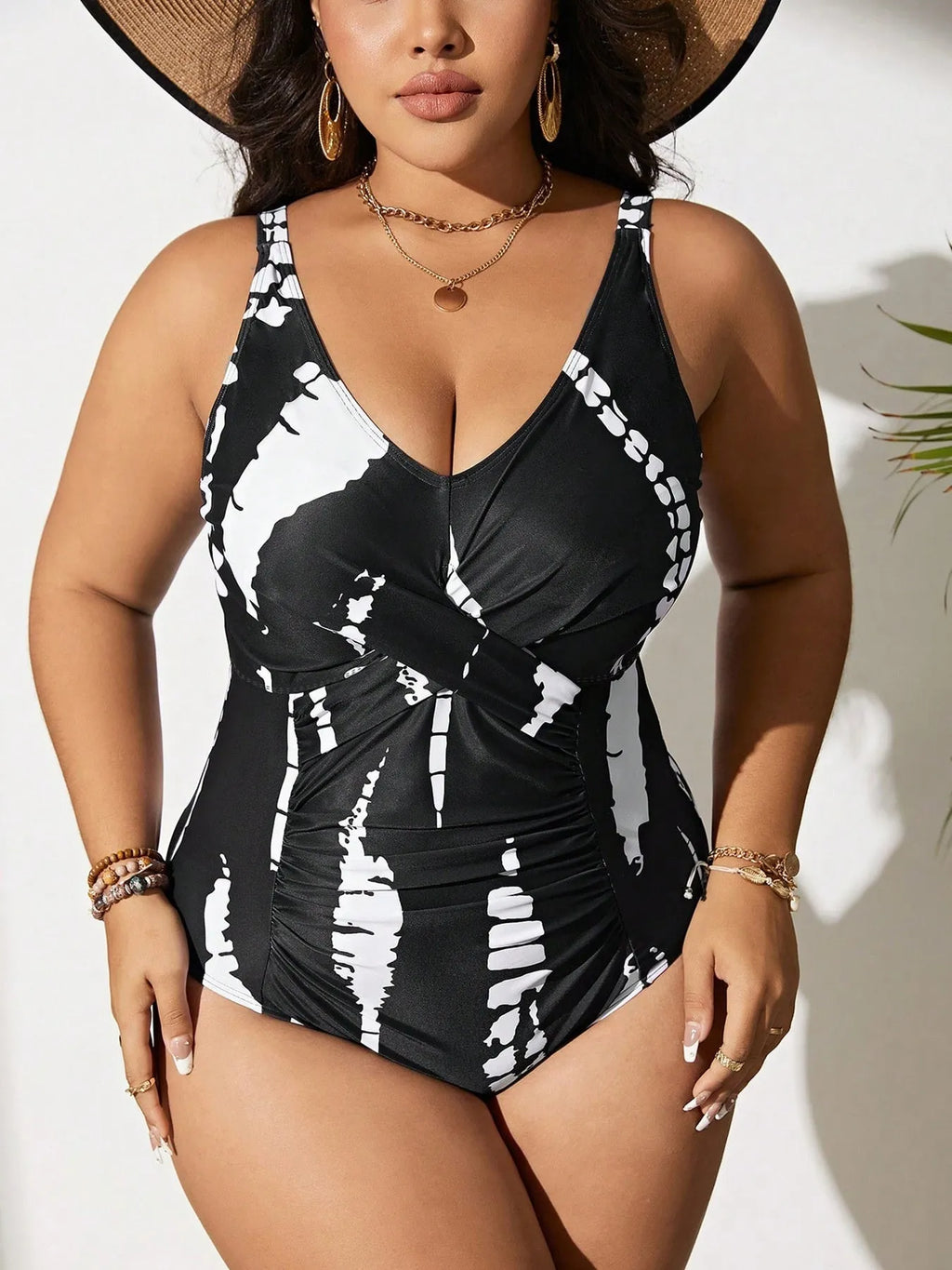 Black conservative one-piece swimsuit on a mannequin, showing sleeveless design and Siamese colour matching pattern.