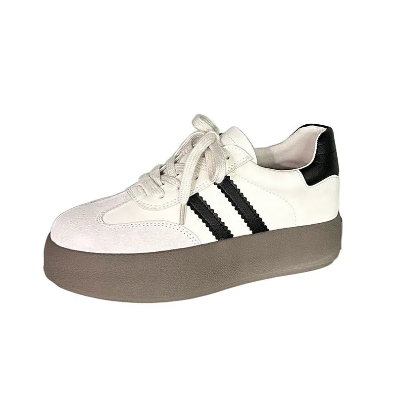 Women's beige distressed leather sneakers with round toe and lace-up front on a rubber sole.