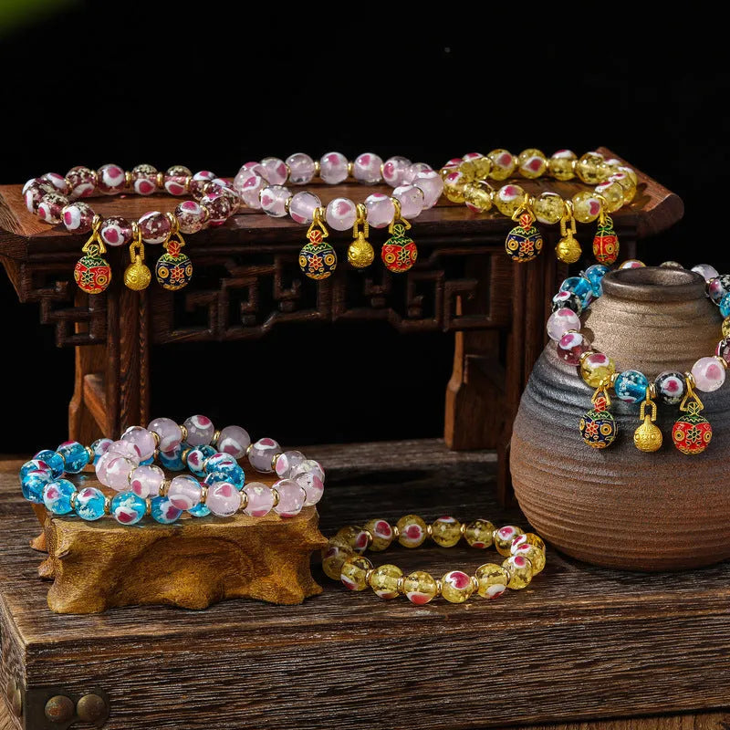 Handmade fluorescent glaze bracelet with swallowing gold beast motif on heart-shaped 10mm beads