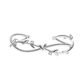 White gold sprout branch bracelet with cross twisted design on a wrist.
