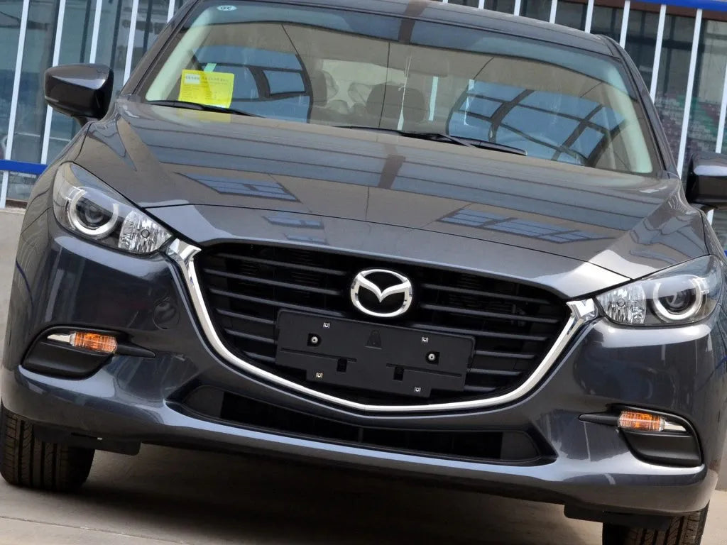 Mazda 3 Exela large headlamp cover replacement part with tube of snake glue adhesive.
