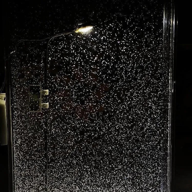 DIY kit for assembling a snowy landscape night light with LED effects on a desktop.